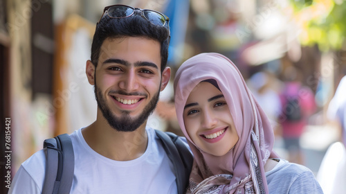 A smiling Middle Eastern couple poses for the camera.