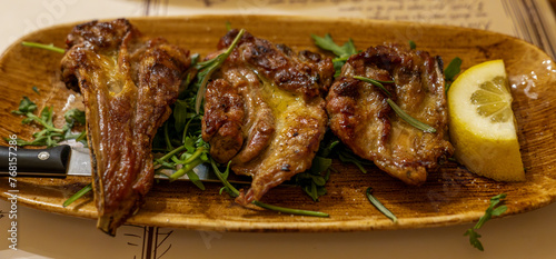 Lamb chops, Italian style with lemon and greens. Close-up, Selective focus. photo