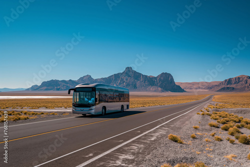 Modern coach bus on a scenic highway with desert landscape and blue sky background