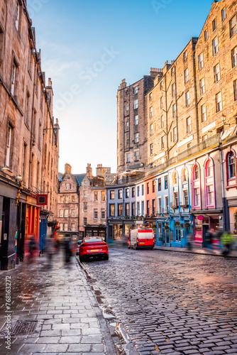 A sunny view of the colorful storefronts and old architecture along Victoria Street in Edinburgh Old Town, Scotland