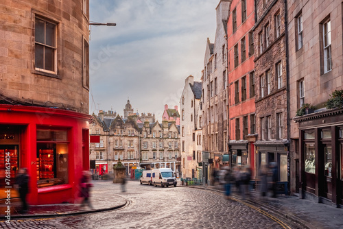 A bright red storefront and old buildings along West Bow and Victoria Street in Edinburgh Old Town, Scotland photo