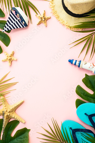 Summer flat lay background. Palm leaves, sea shells and accessories on pink. © nadianb