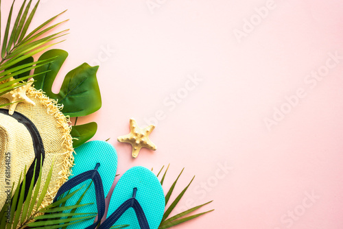 Summer flat lay background. Palm leaves, sea shells and summer cloth on pink background. © nadianb