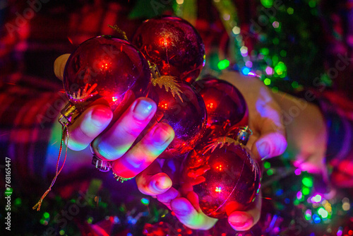 Girl holding New Year's balls in her hands close-up 