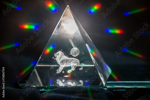 Transparent glowing triangle with a 3D lion inside and rainbow highlights 
