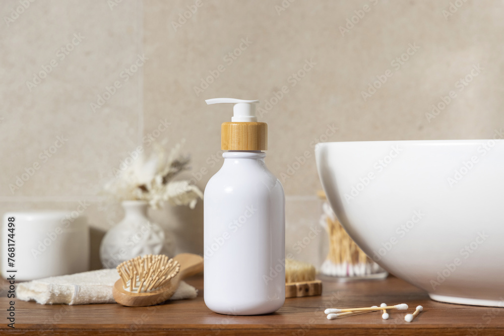 Cosmetic bottle near personal care products on wooden countertop in bathroom, mockup