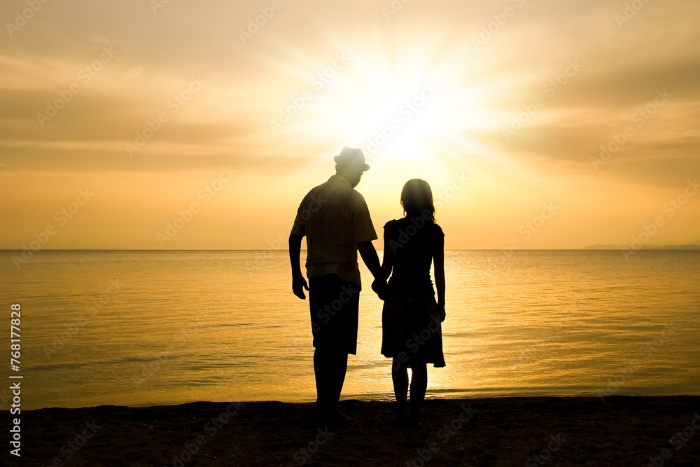 A happy couple by the sea on nature in travel silhouette