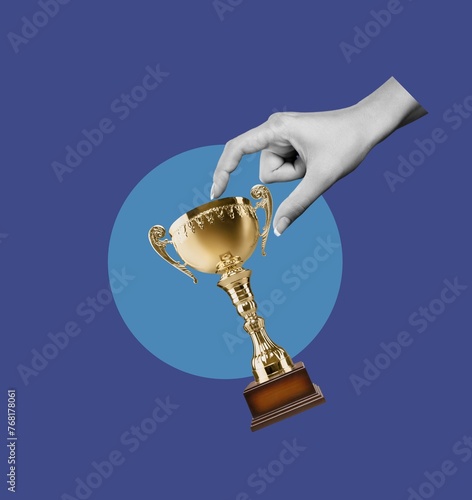 Champion golden trophy in winner hand