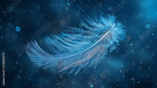 A delicate blue feather floating with bokeh background.