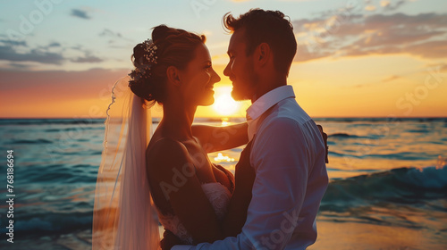 Romantic couple on beach at sunset, newly married happy two people standing together looking at each other, Close up portrait © amila