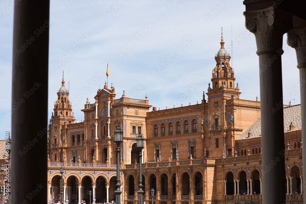 The beautiful decorated Plaza de España (English: Spanish Square) during an colourful sunrise is a touristic spot in a park in the centre of Seville, andalusia, spain.