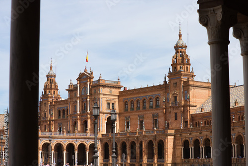 The beautiful decorated Plaza de España (English: Spanish Square) during an colourful sunrise is a touristic spot in a park in the centre of Seville, andalusia, spain.