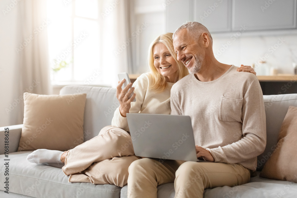 Mature couple enjoying technology together Mature couple enjoying technology together