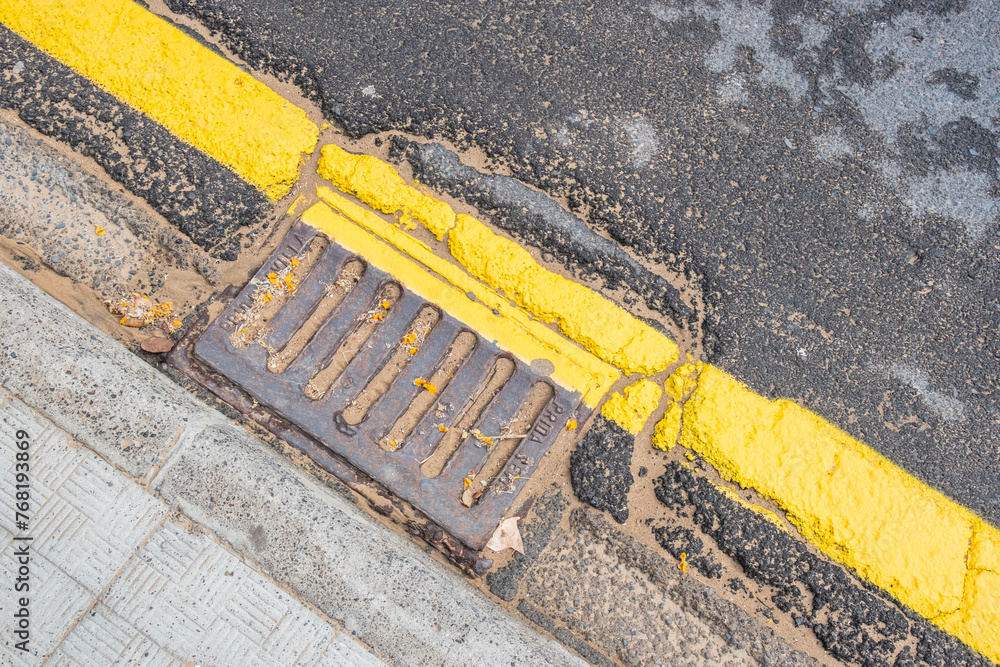 Fototapeta premium the old water drain is clogged with sand and the yellow line
