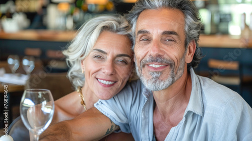 60 years couple with black hair sitting in restaurant