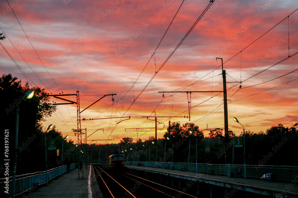 Amazingpink-yellow sunset on  station  (electrical train (maybe D2 or D1 or D3 or D4)  in Moscow Oblast