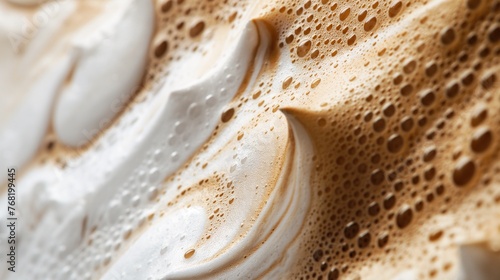 Close up image of hot coffee in white muck, creamy coffee foam texture backgrounds.