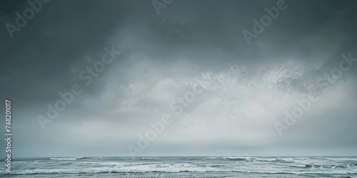 A vast body of water under a dramatic grey sky filled with clouds. Dramatic grey sky.