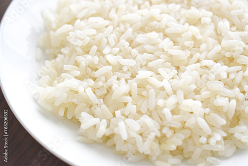 Cooked parboiled rice on a white plate. 