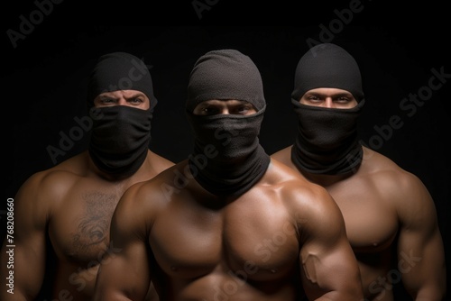man in mask. Three muscular men in balaclavas with bare chests.