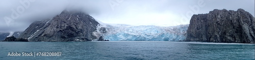 Panorama of a glacier meeting the ocean between two mountains, on Elephant Island, Antarctica © Angela