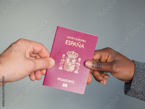 two hands holding a spanish european union passport