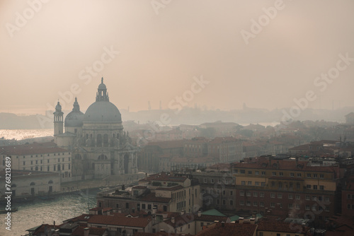 Misty day in Venice: View from San Marco Campanile captures Grand Canal, Basilica di Santa Maria della Salute, and foggy city skyline. © Miguel