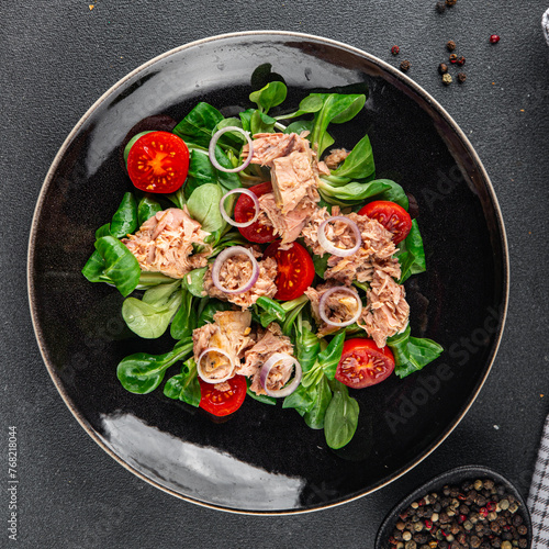 tuna salad, tomato, green leaf lettuce, onion healthy eating cooking appetizer meal food snack on the table copy space food background rustic top view © Alesia Berlezova