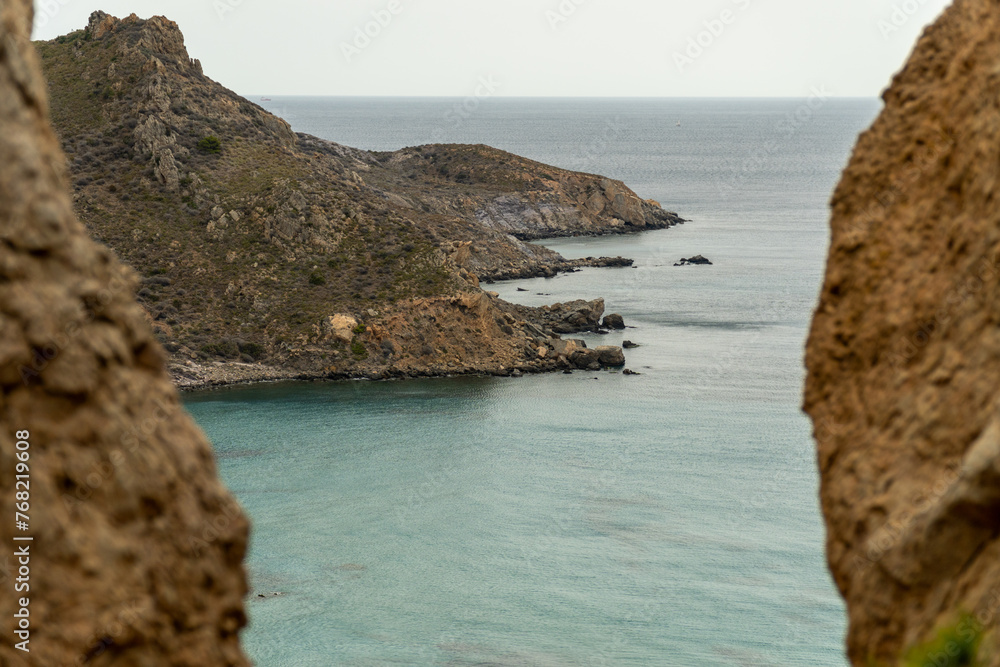 Fototapeta premium Wild and lonely beach, surrounded by cliffs