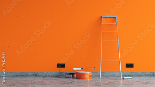 A ladder, paint roller, and tray sit ready for wall painting in a room with a freshly painted orange wall.
