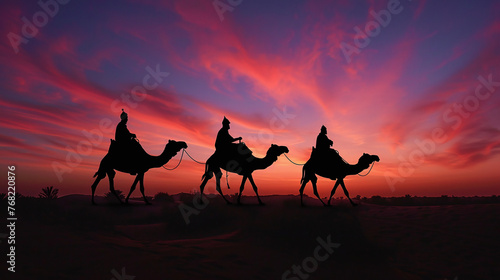 Silhouette of Three Wiseman Riding their Camels on the Desert Horizon. Christmas holiday concept, visit of baby Jesus, on the way to the city of Bethlehem photo
