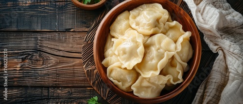 A rustic wooden bowl filled with plump, freshly steamed dumplings sits on a wooden surface, inviting a taste of traditional cuisine.