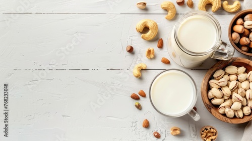 a bottle of milk  assorted nuts  and a half-cut coconut arranged on a pristine white wooden table against a clean and simple backdrop  accentuated with bright colors.