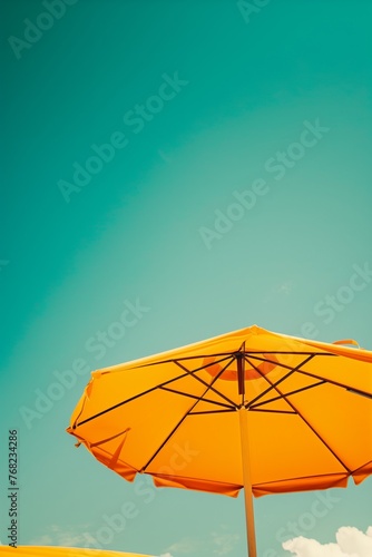 view from the bottom of bright beach umbrella and sky  retro colors