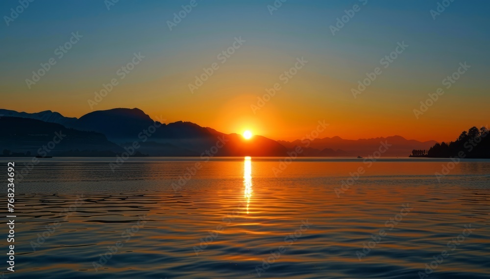 Sun Setting Over Lake With Mountains