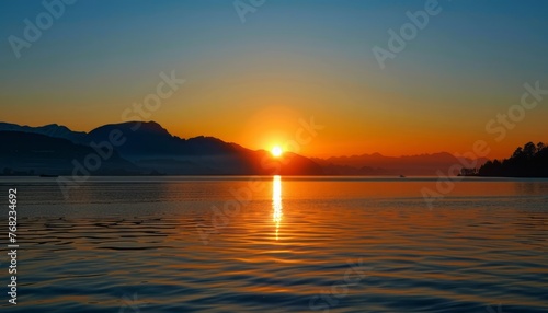 Sun Setting Over Lake With Mountains