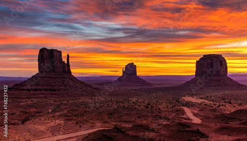 Bright orange and blue sunset covers the rock formations of Oljato-Monument Valley. 