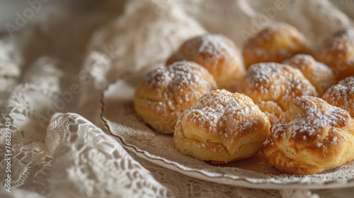 Melitini Cookies Dusted with Powdered Sugar on Lace Tablecloth