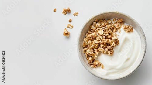 a bowl filled with Greek yogurt topped with granola, positioned centrally on a light background, with additional granola or wheat in the foreground to accentuate its traditional style.