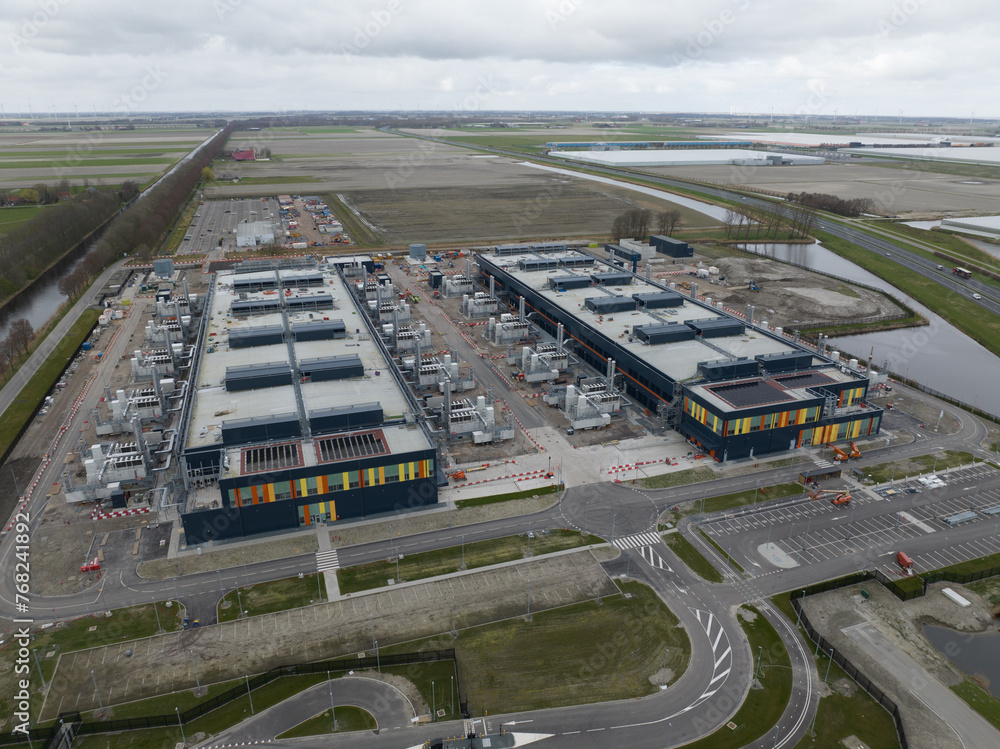 The construction of a large new data center located on the Agriport business park in Middenmeer, The Netherlands. Internet and information technologies and Artificial intelligence infrastructure - obrazy, fototapety, plakaty 