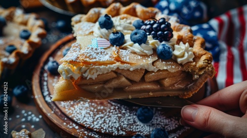 Piece of apple pie topped with whipped cream and fresh blueberries, with small American flag decoration