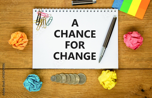 A chance for change symbol. Concept words A chance for change on beautiful white note. Beautiful wooden table background. Colored paper. Black pen. Business A chance for change concept. Copy space.