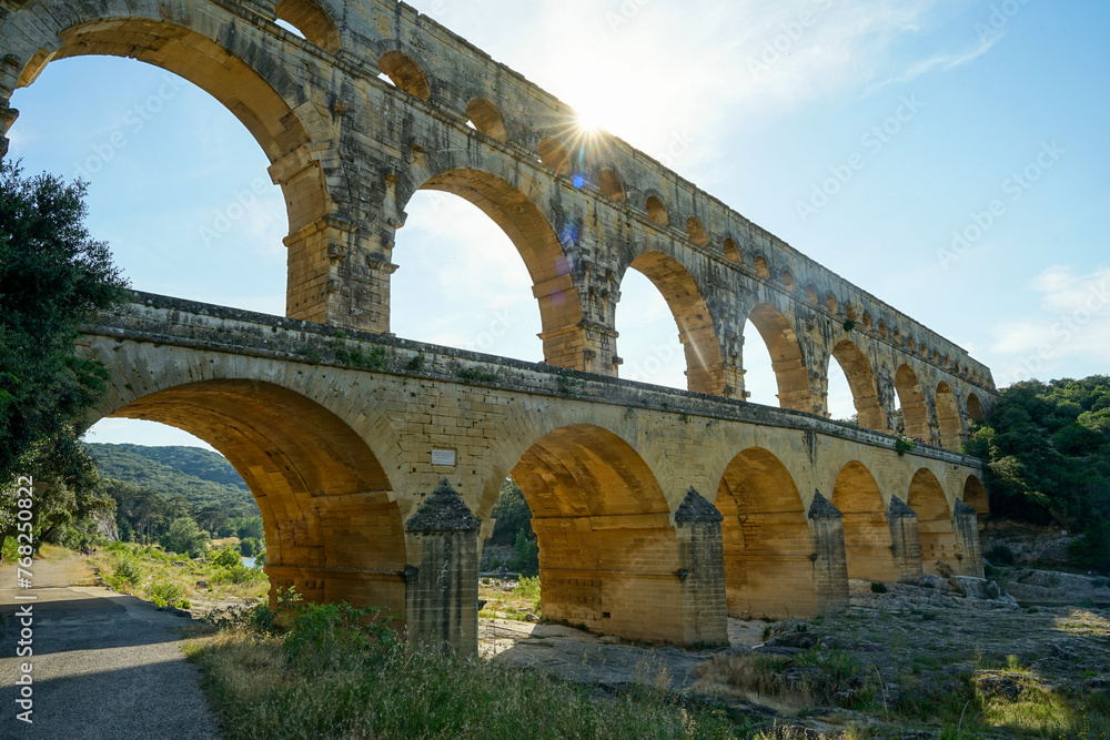 Pont du Gard famous aqueduct bridge with three arched tiers, built in first century by Romans, popular tourist landmark, France