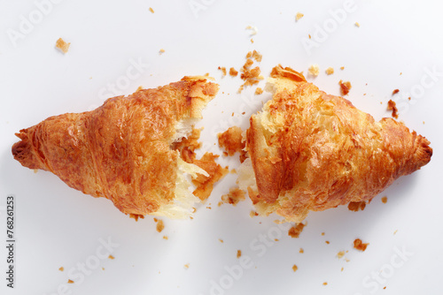 Broken croissant with crumbs