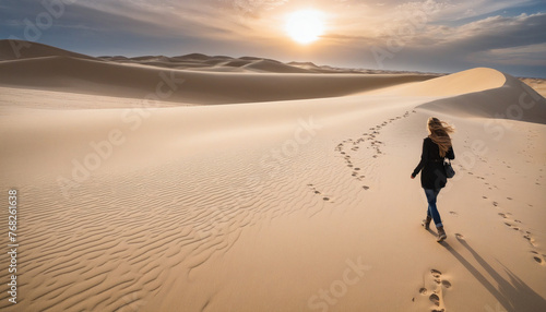 woman casual cloth walking look at the wonderful stunning attraction famous view of the sand dune sunset photo
