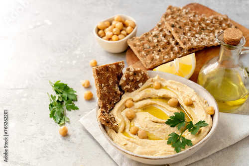 Fresh hummus with chickpea olive oil and limen with multigrain crackers photo