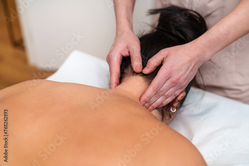Slika na platnu Close-up of a masseur's hands providing targeted neck massage therapy