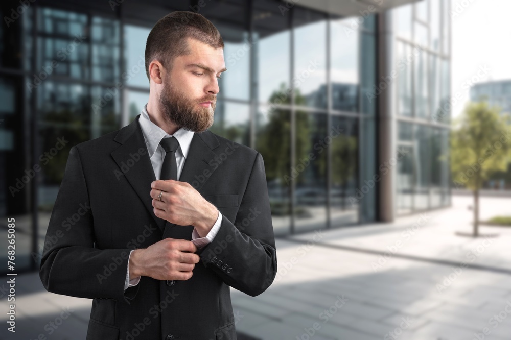 Portrait of successful businessman in suit working inside office building Portrait of successful businessman in suit working inside office building