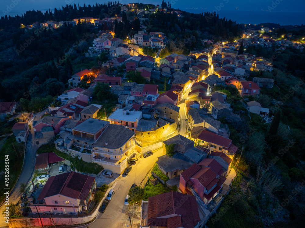 Aerial drone view of beautiful Karousades village by night in north corfu,Greece