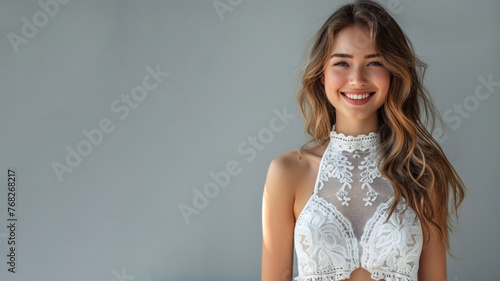 Caucasian woman wearing white halter neck dress smile, isolated on gray